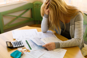 stressed woman agonizing over bills